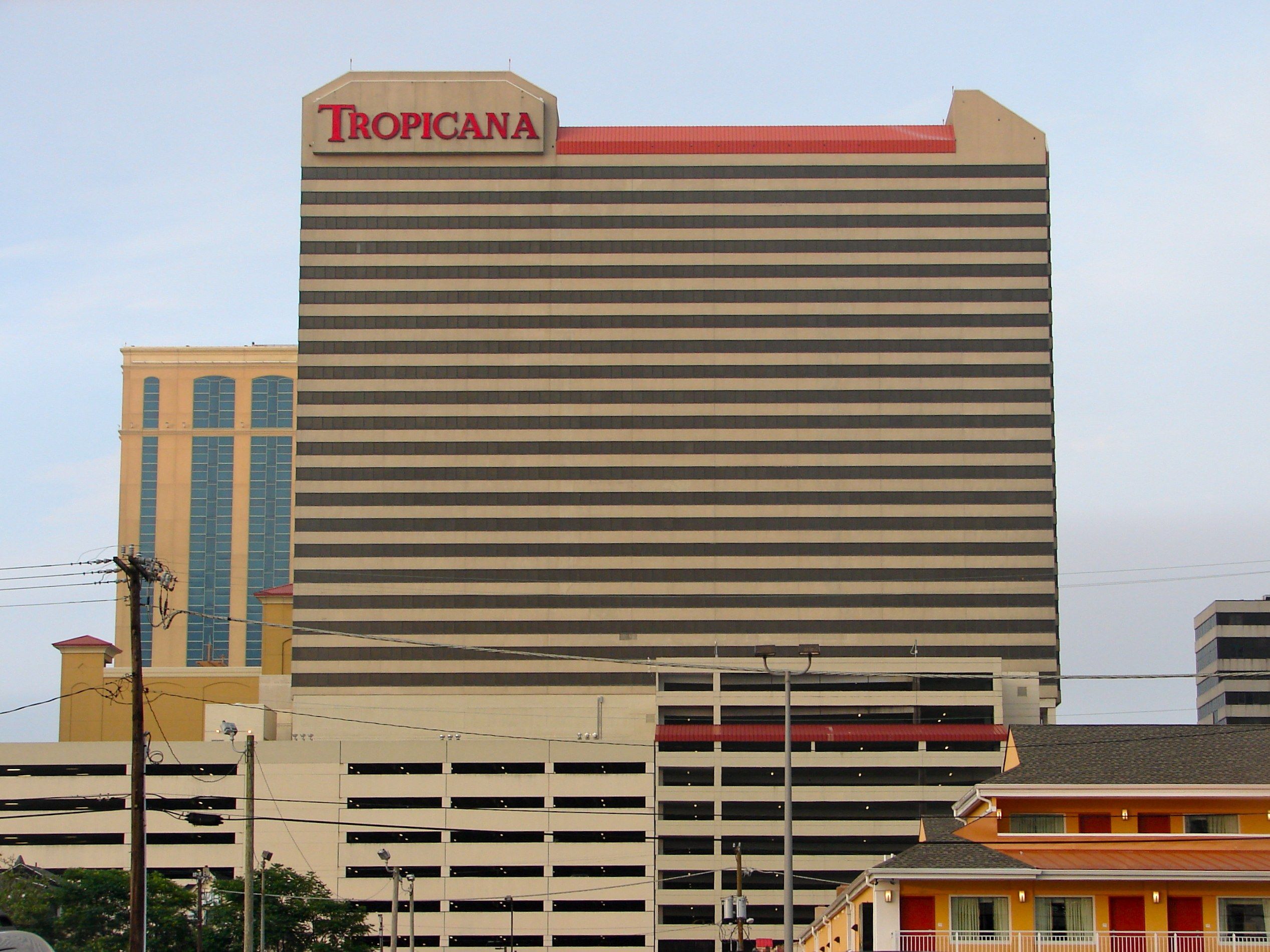 The image shows the Tropicana Hotel and Casino in Atlantic City, New Jersey. It is a large building...