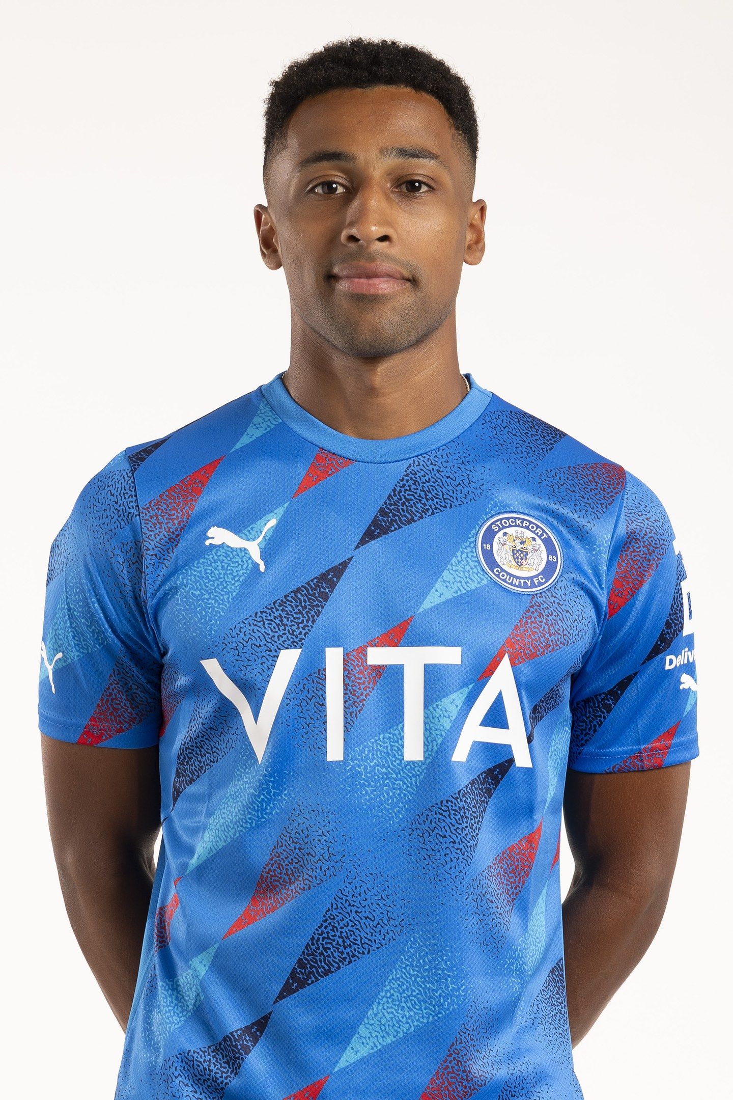 The image shows a man wearing a blue Leicester City Away Shirt from the 2019/20 season, with the...