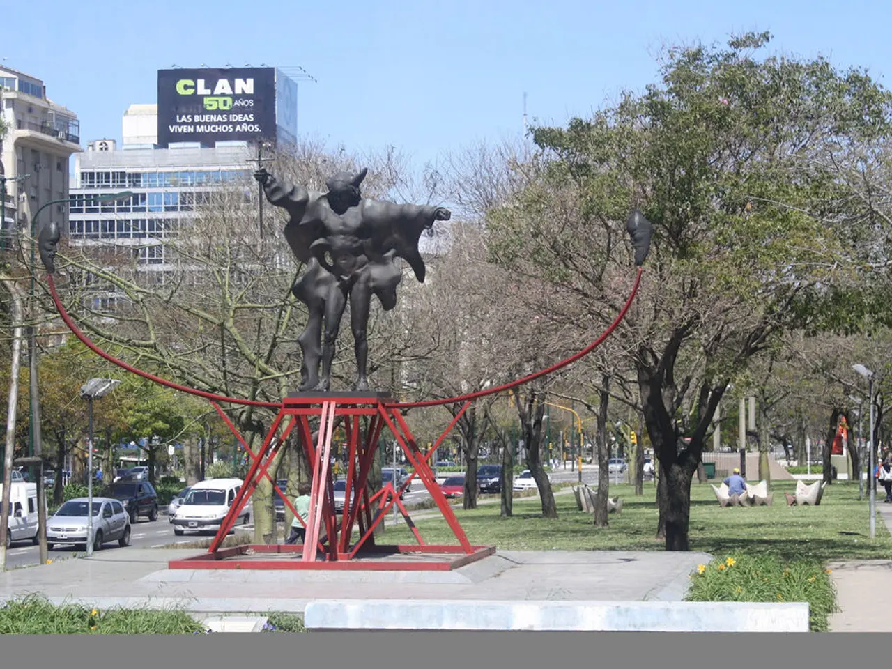 In the image we can see the sculpture and metal decoration. Here we can see trees, buildings and...