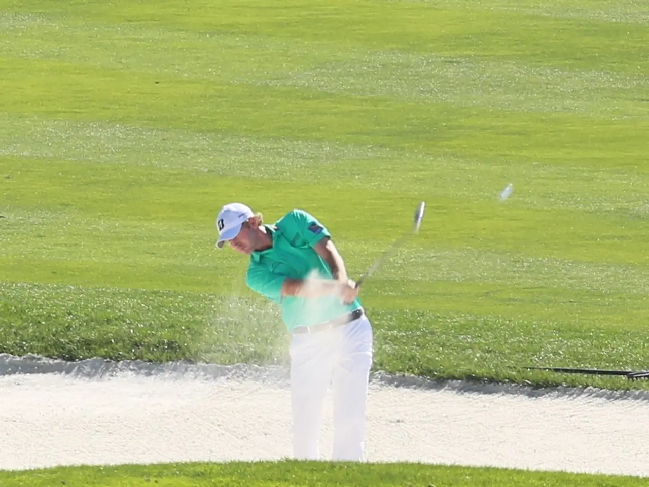 This image consists of a man playing golf. At the bottom, there is green grass. In the middle,...