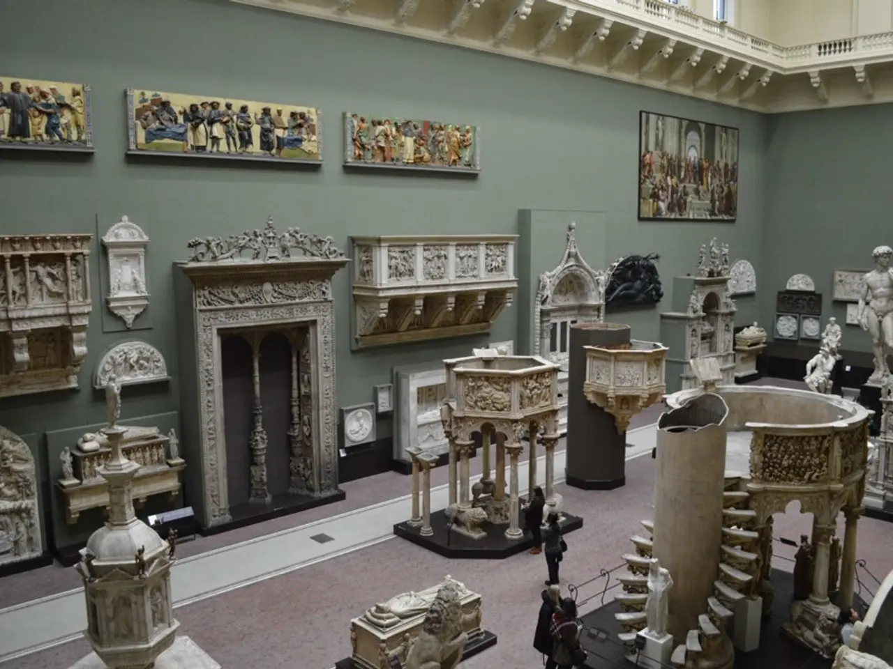 In this picture I can see few statues and I can see sculptures and few photo frames on the wall and...