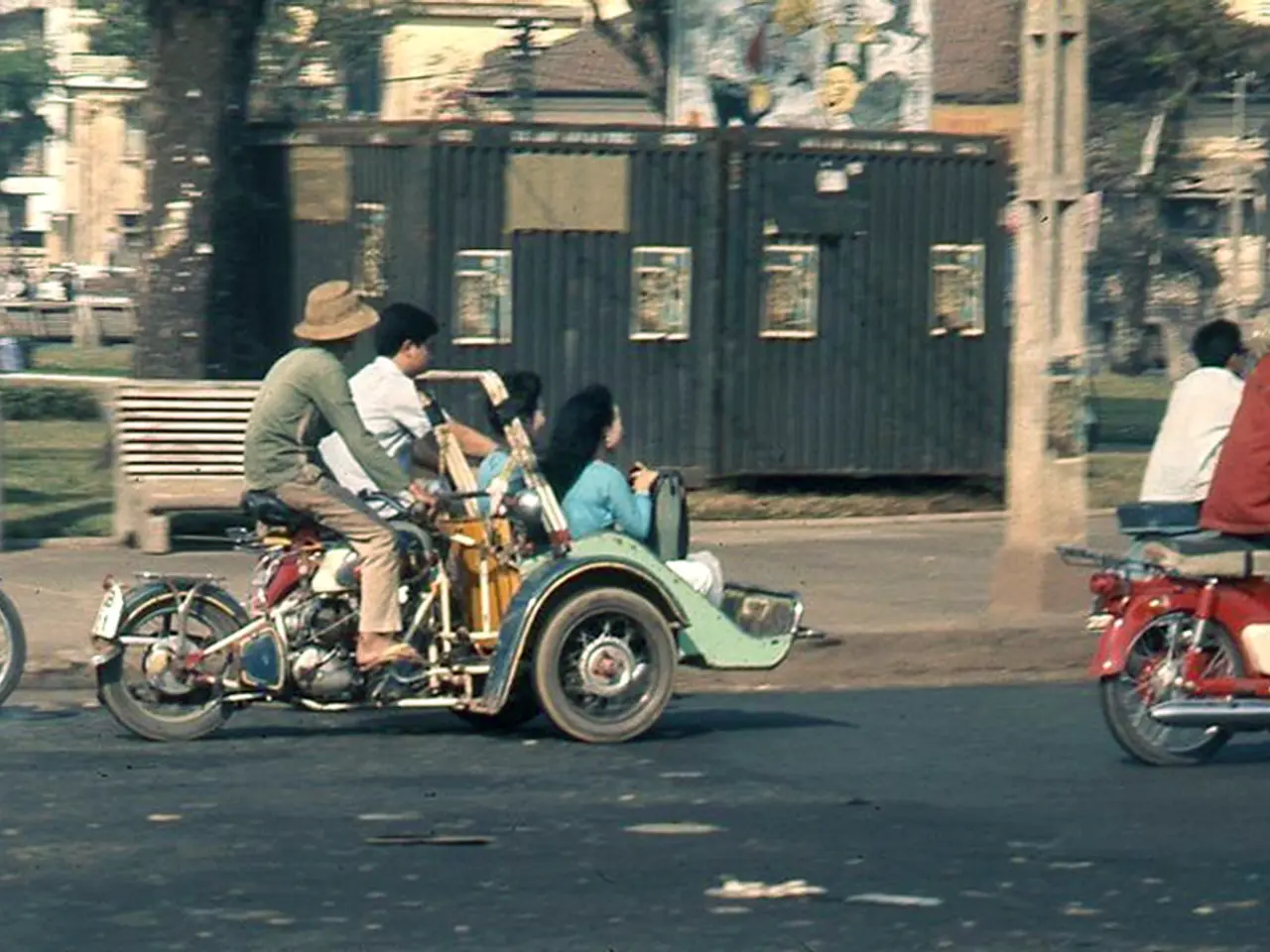 This image is clicked on road. There are few people riding motorbikes. Behind them there is a...