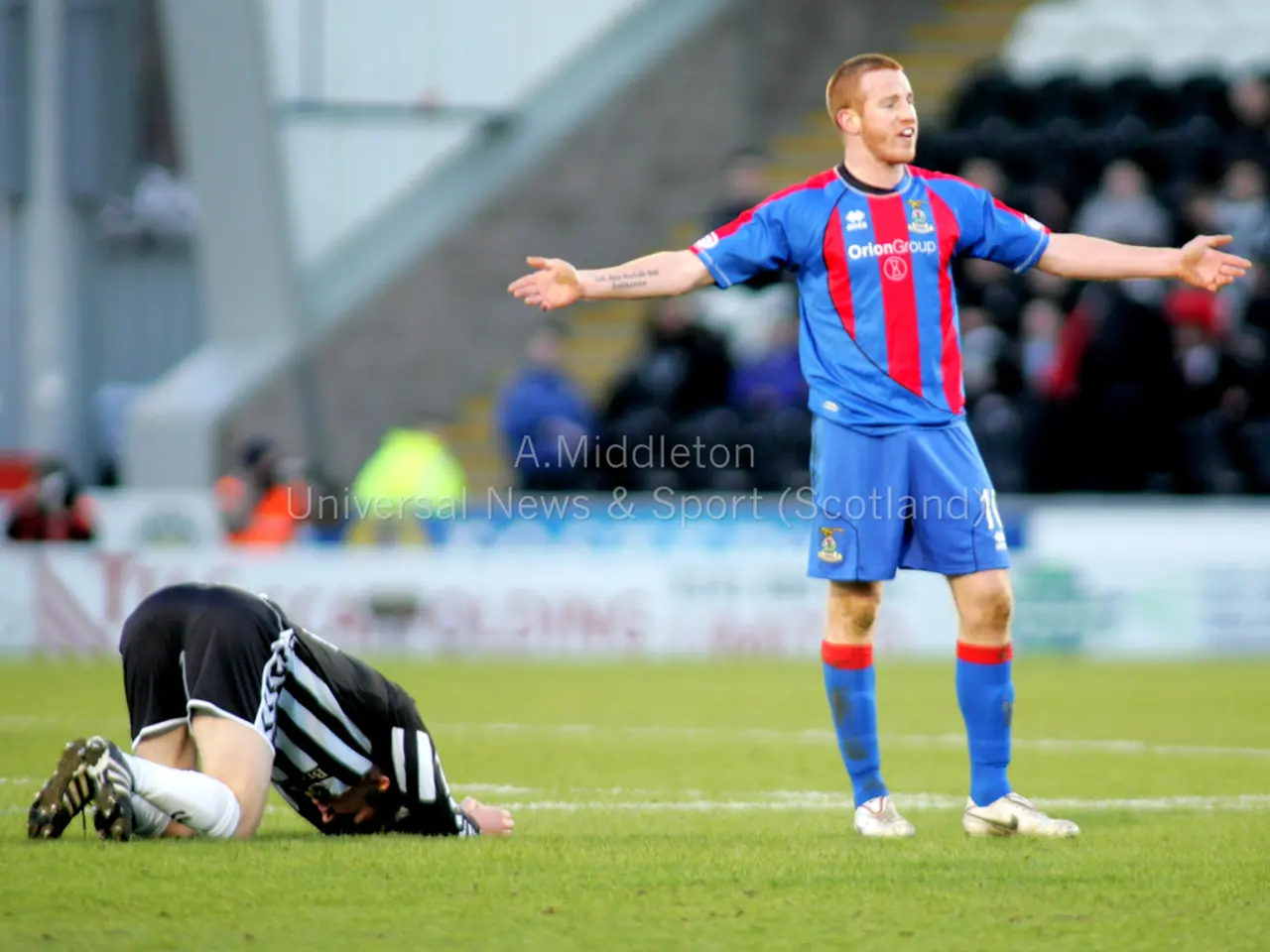 This is the picture of a stadium. In this image there is a person standing and there is a person...