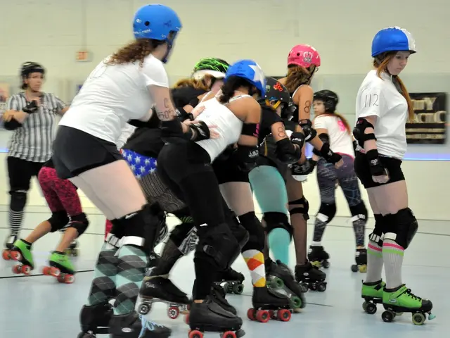 In this image I can see a group of people are skating on the floor. In the background I can see a...