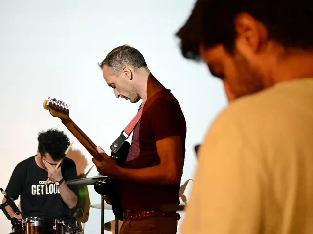 There are 3 people here playing musical instruments and this is a microphone.