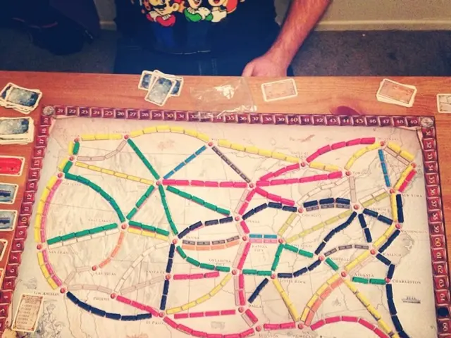 In the middle of the image there is a table, on the table there are some cards. Top of the image a...