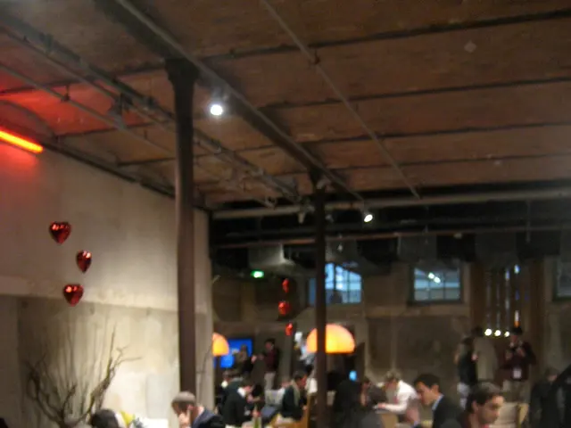 This image is clicked inside a restaurant. There are many people sitting in this image. To the...