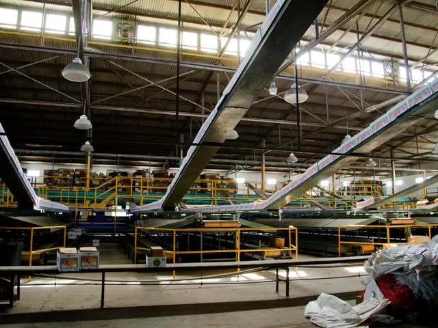 This is an inside view of a factory. There are a few sheets and clothes on the right side. We can...