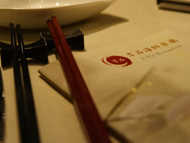 A table on which there is a menu card which is titled in mandarin and English. It is labelled as ji...