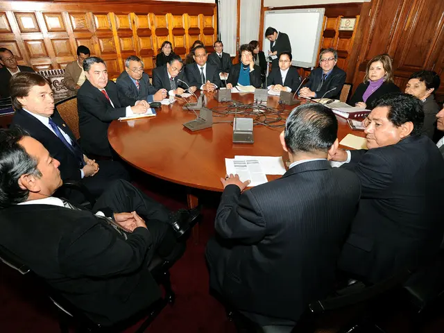 In the image it seems like it is a round table meeting in which there are delegates sitting around...