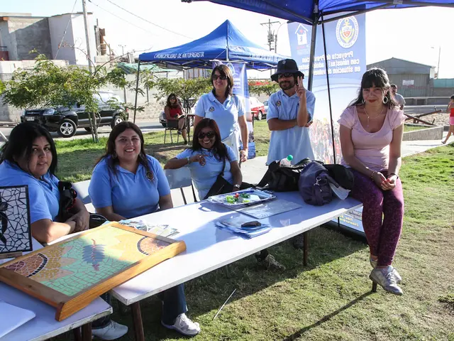 It is an open area there are group of people sitting around a table,on the table there are some...