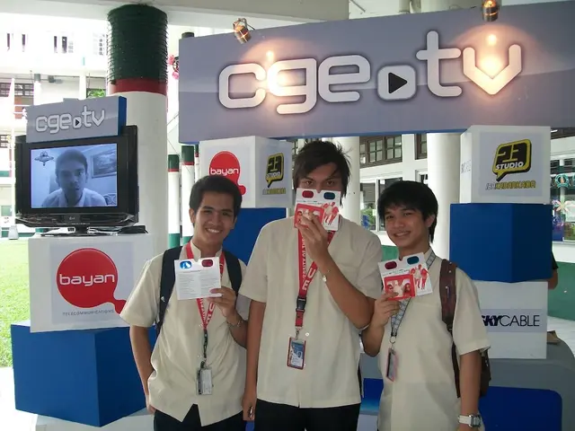 In this image we can see three men standing on the floor and holding cards in their hands. In the...