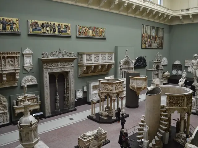 In this picture I can see few statues and I can see sculptures and few photo frames on the wall and...