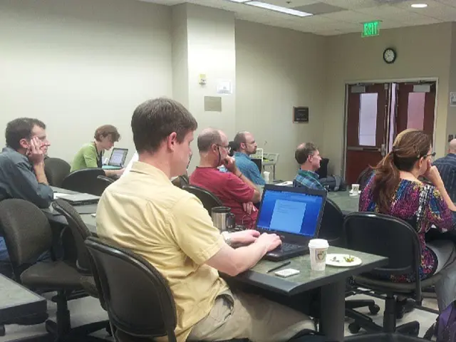 Many persons are over here. It is looking like a room. There are chairs and tables. On the table...