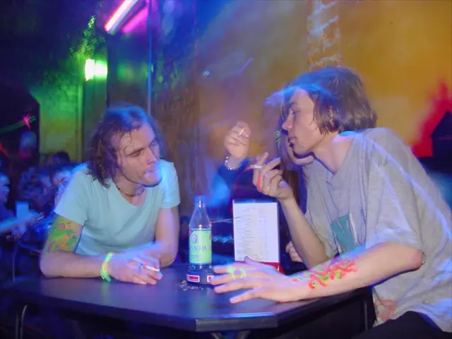 This image is taken indoors. In the background there is a wall and there are two lights. A few...