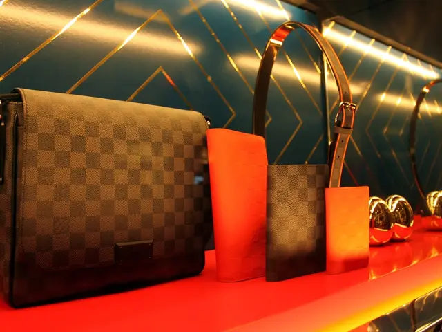 There is a table. There is a wallet,handbag and belt on a table.