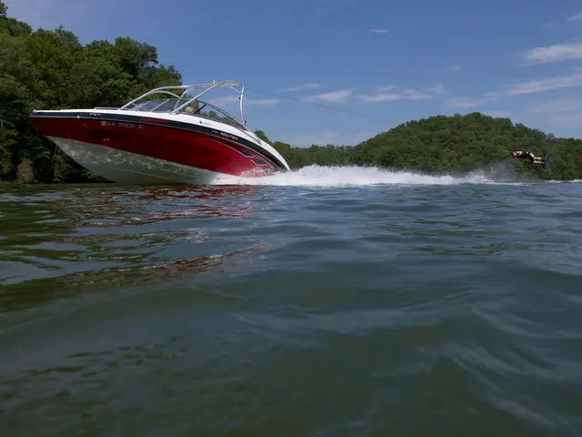 In this image a man performing a wake surfing behind the boat in the river in the background there...