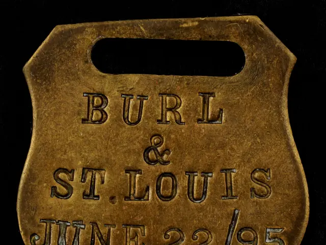 The image shows a brass badge with the words "Burl & St. Louis" inscribed on it against a black...