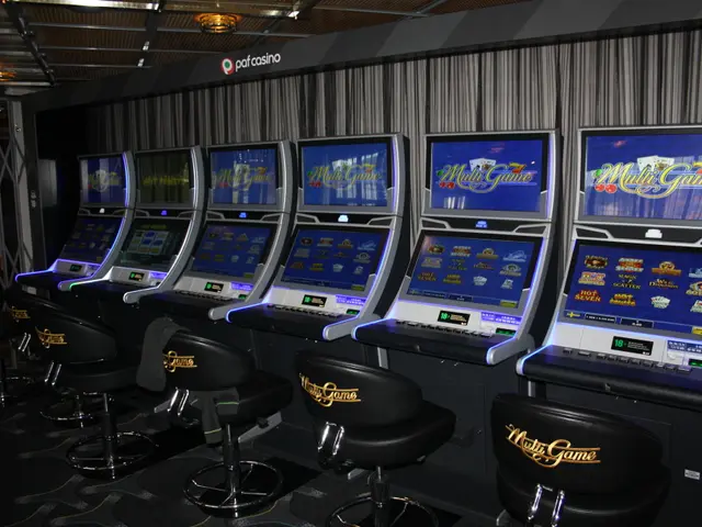 The image shows a row of slot machines in a casino, with chairs on the floor and a wall in the...