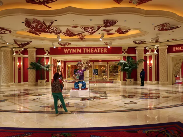 The image shows the Wynn Hotel and Casino in Las Vegas, Nevada. We can see a group of people...