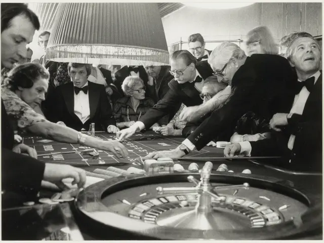 The image shows a black and white photo of a group of people playing roulette at a casino. There...