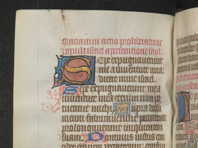 The image shows an open book with an illuminated manuscript featuring a letter 'S' in the center....