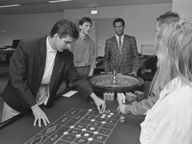 The image shows a group of people playing roulette in a casino. There are four people standing...