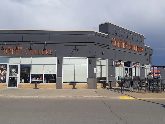 The image shows a coffee culture coffee shop on the corner of a street, with a road in the...