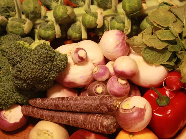 The image shows a wooden table topped with a variety of vegetables, including broccoli, brussels...