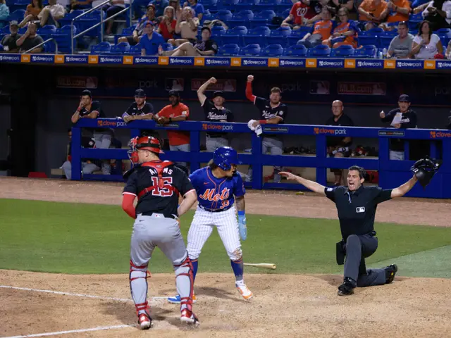 The image shows a baseball player sliding into home plate during a game. We can see a group of...