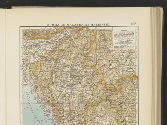 The image shows an open book with a map of Burma and Malaysia on it, set against a black...