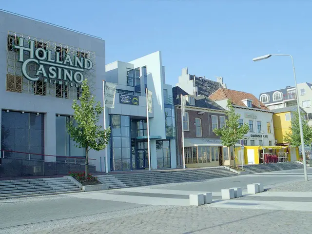 The image shows the Holland Casino in Amsterdam, Netherlands. It features buildings with windows,...