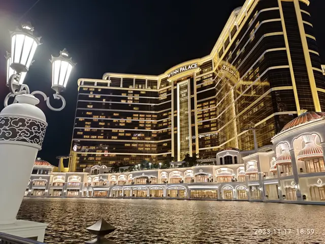 The image shows the Wynn Palace Hotel and Casino in Las Vegas, Nevada. It is a large building with...