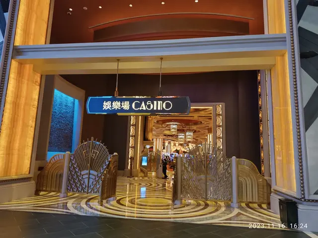 The image shows the entrance to a casino with a sign that reads "Casino" at the top of the image....
