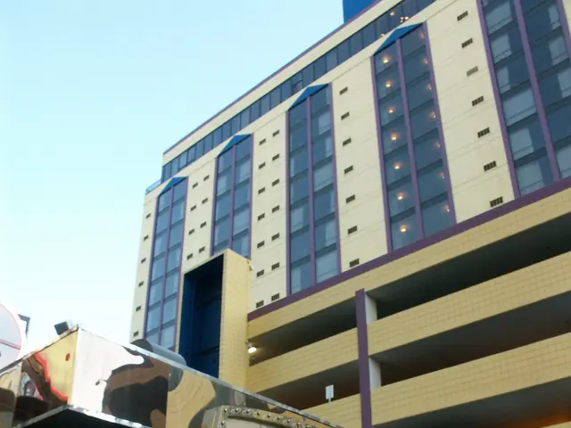 The image shows the Sands Hotel and Casino in Las Vegas, Nevada. It is a large building with glass...