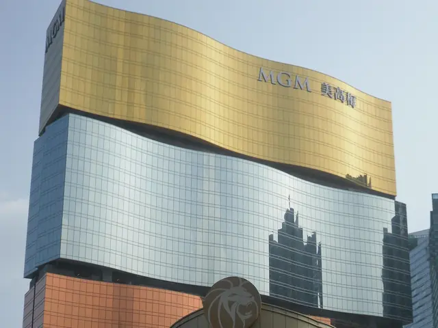 The image shows the MGM Grand Hotel and Casino in Macau, China. We can see vehicles on the road,...