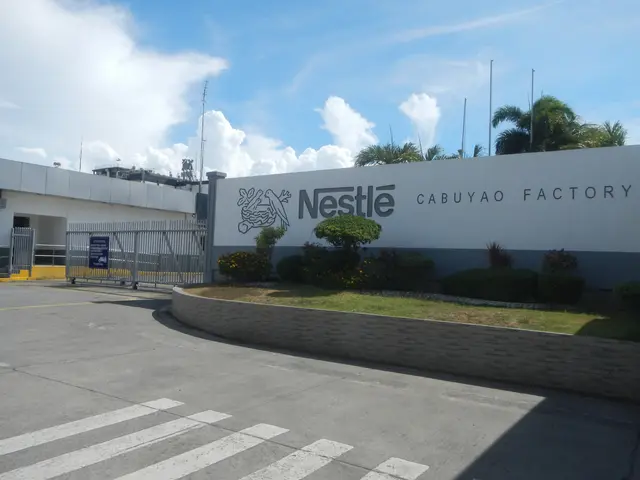 The image shows the Nestle Cabuyao Factory in the Philippines, with a road in the foreground, a...
