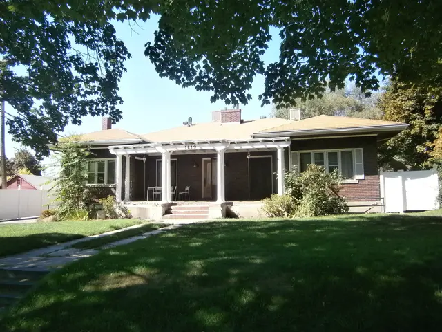 The image shows a bungalow with a roof, windows, pillars, doors, chairs, plants, grass, a pathway,...