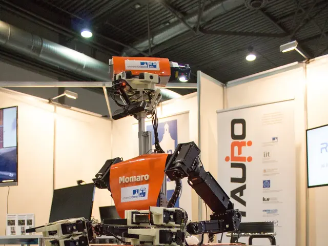 The image shows a robot sitting on top of a table in a room, surrounded by metal poles, a...